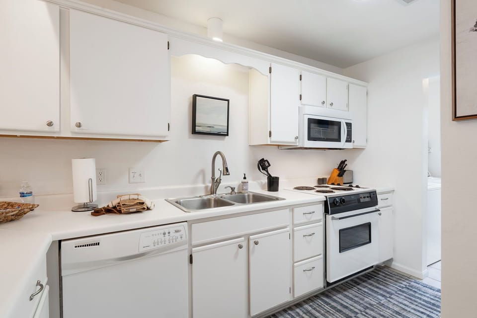 Full sized kitchen with lots of storage, cookware, dishwasher, microwave & range
