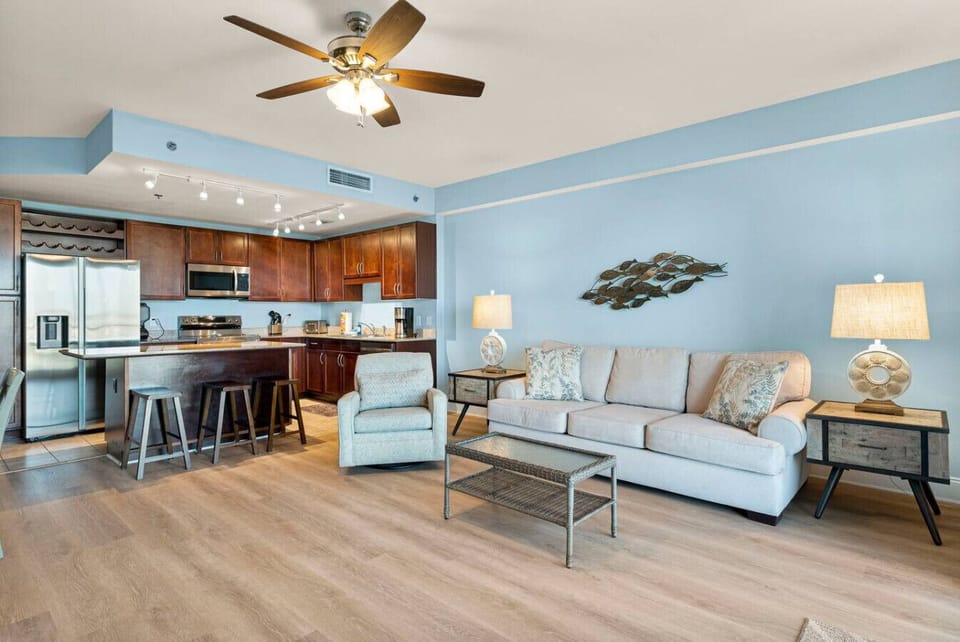 Living Area with Lake and Light Show Views, Flat Screen TV, Sleeper Sofa, and Private Balcony