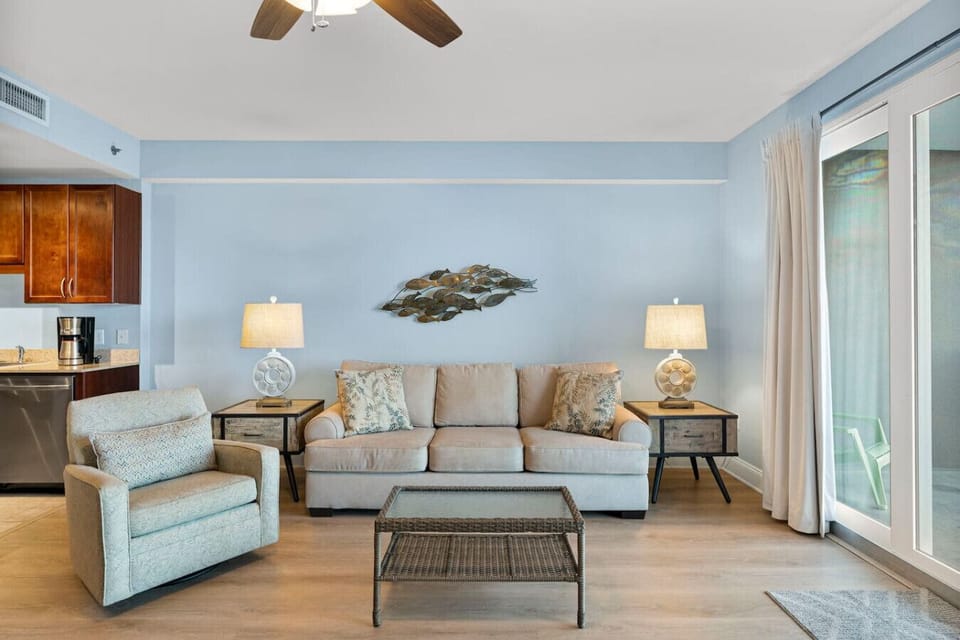 Living Area with Lake and Light Show Views, Flat Screen TV, Sleeper Sofa, and Private Balcony