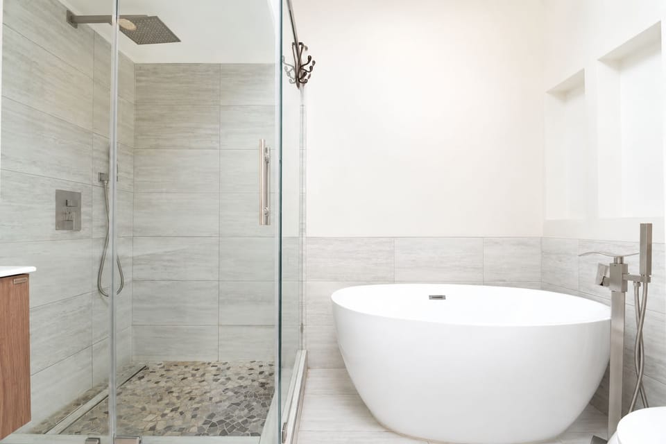 Spa-style bathroom with soaking tub and glass walk-in rain shower