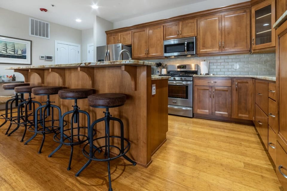 Gorgeous fully stocked kitchen with oversized island, full sized appliances and seating for 5 at the bar.