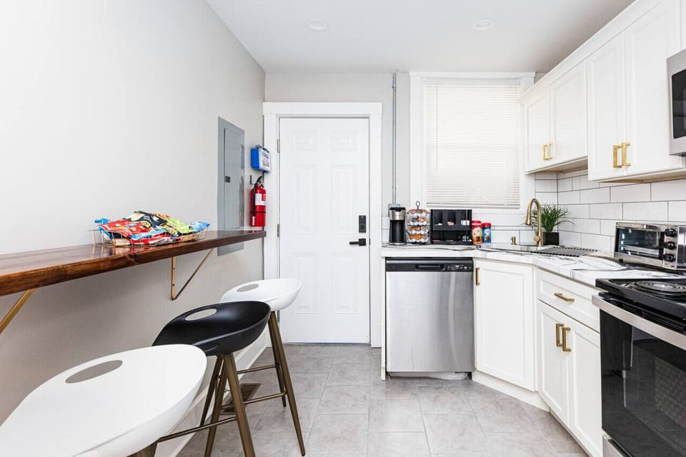 Prepare culinary delights in our fully equipped kitchen, featuring all cooking essentials and meal prepping necessities, along with convenient bar stool seating for casual dining.