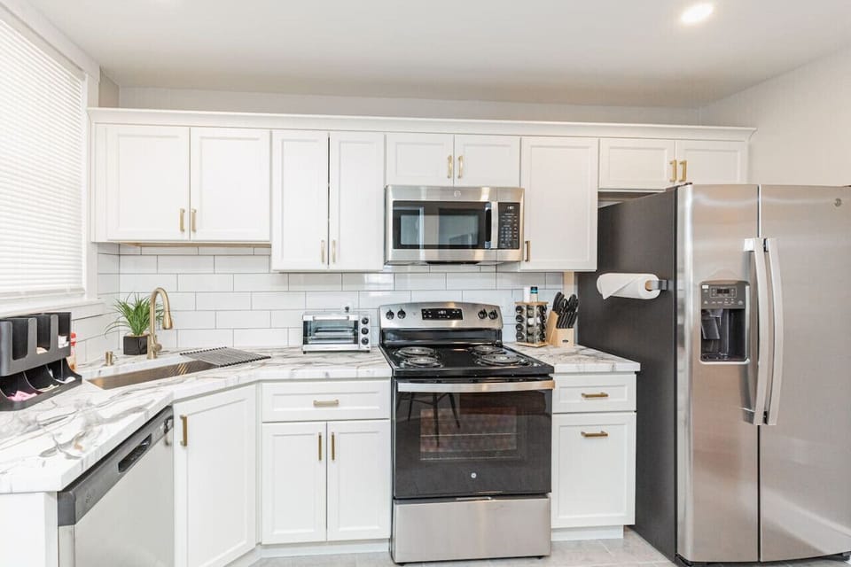 Cook up a storm in our fully equipped kitchen, boasting bar stool seating, a dishwasher, microwave, coffee station, and more, perfect for enjoying meals together.