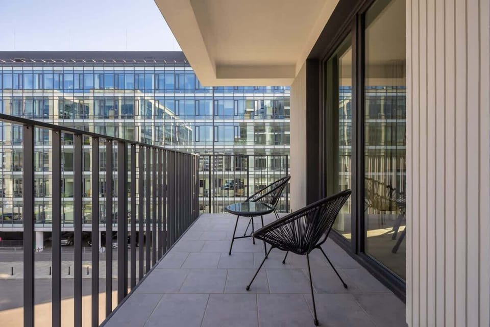 Another perspective of the balcony, highlighting its spacious design and comfortable seating.

