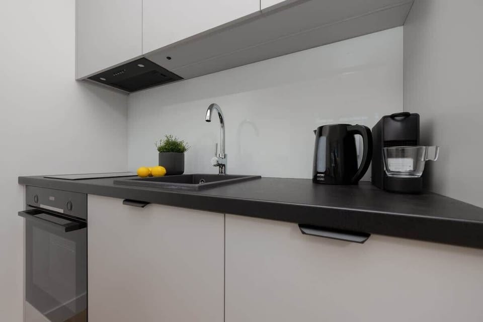 Another view of the kitchen, showcasing a coffee station with a black kettle and espresso machine.







