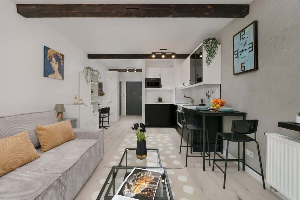 A different angle of the open-plan space, highlighting the dining area, kitchen, and warm-toned decor.


