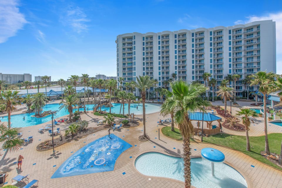 The Palms Resort complex featuring extensive water facilities with multiple pools, waterslides, and tropical palm landscaping.