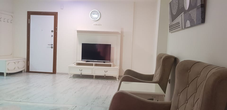 Family Apartment | Living area | 104-inch LED TV with satellite channels, iPod dock, printers