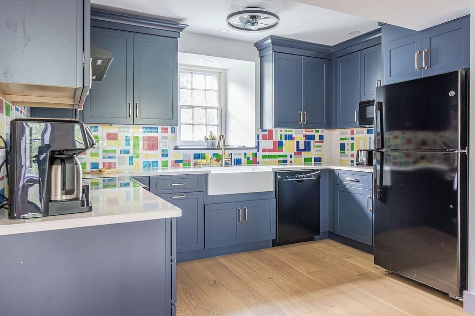 Everything brand new!! Beautiful  kitchen with new appliances, induction stove, microwave, dishwasher.   Everything you need for a family dinner together.  Be-spoke handmade tiles for backsplash.