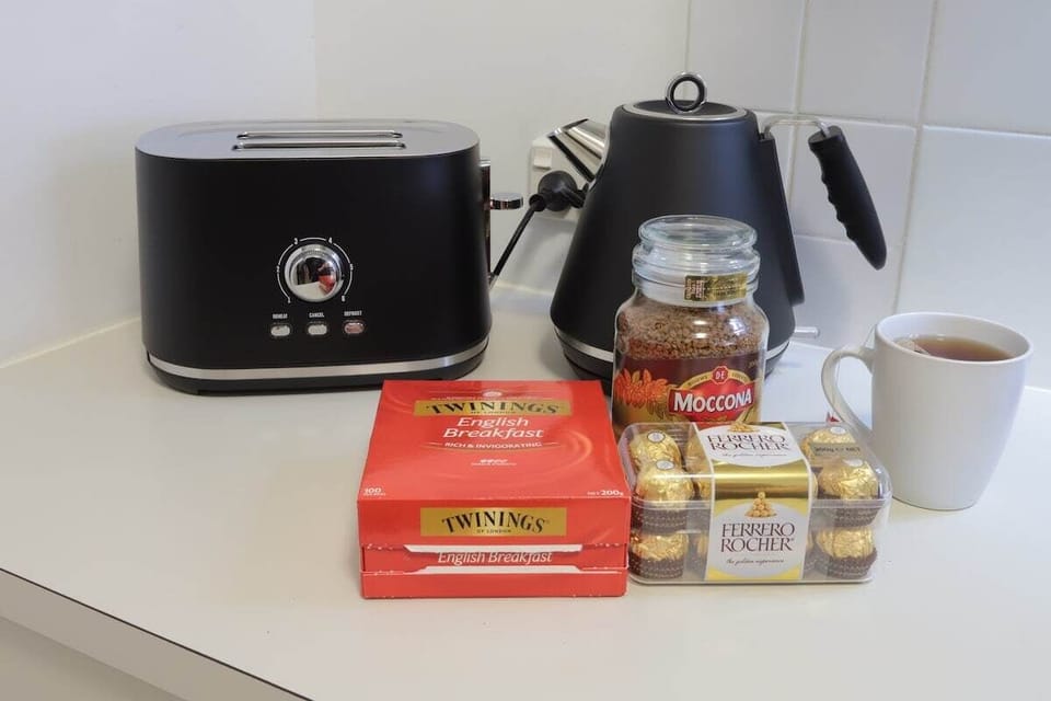Self-contained kitchen with space for coffee, snacks and simple meals.