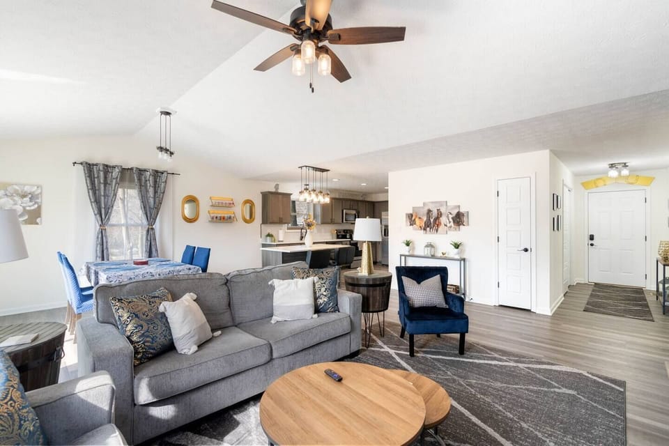 spacious living area with queen sized couch bed, tv, and electric fireplace heater