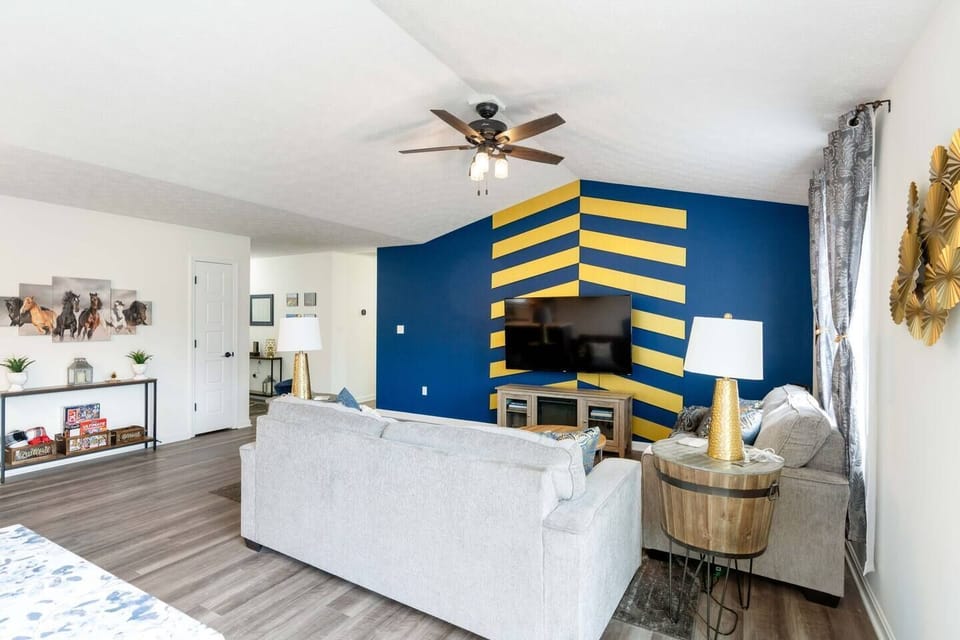 spacious living area with queen sized couch bed, tv, and electric fireplace heater