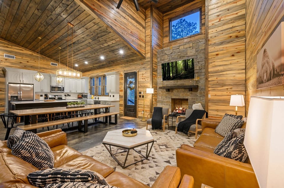 Living Room: Rustic elegance with a stone fireplace and stunning views awaits your escape!