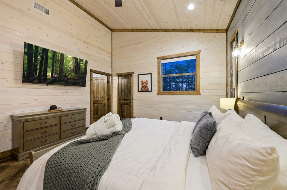 Bedroom Retreat: Relax in style with serene forest views and plush bedding for ultimate comfort!