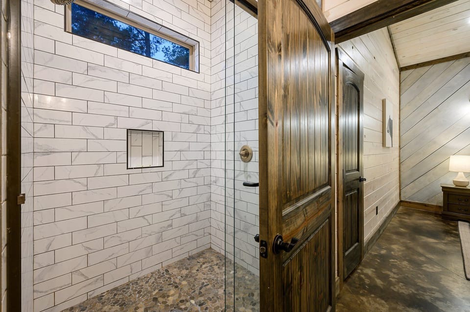 Luxurious Shower Retreat: Experience upscale relaxation with stunning tile and natural light!