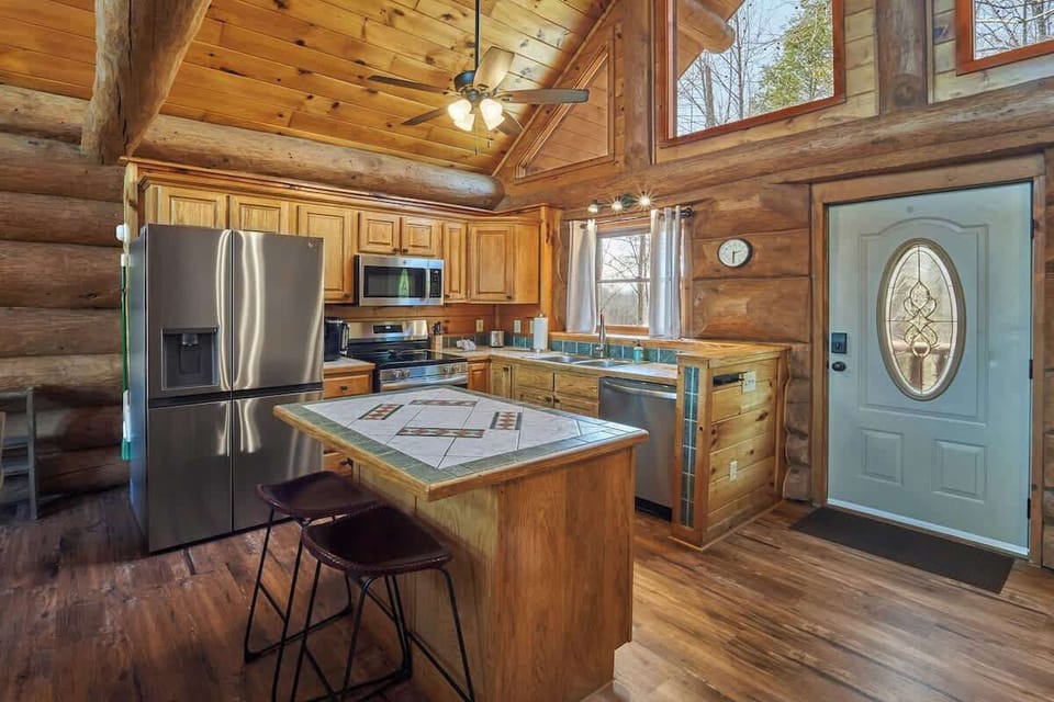 The kitchen area on the main level features all stainless steel appliances and is well stocked for in-cabin meal prep and dining.