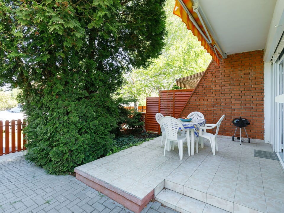 Furniture, Plant, Building, Chair, Table, Shade, Outdoor Furniture, Flooring, Tree, Floor