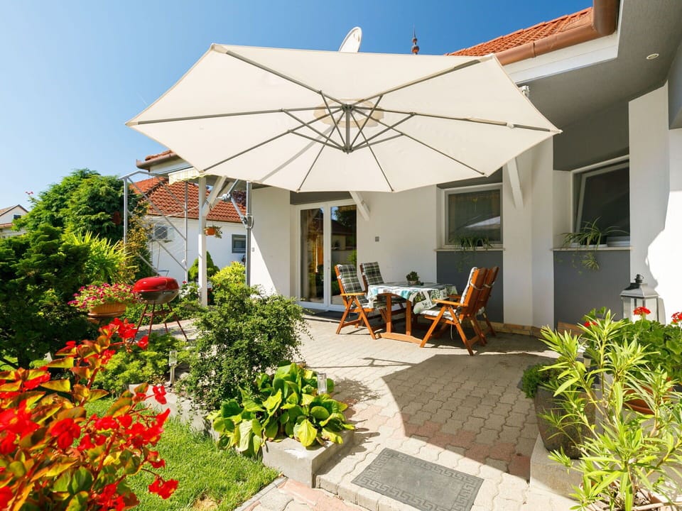 Plant, Property, Flower, Building, Chair, Shade, Sky, Outdoor Furniture, Residential Area, Landscape