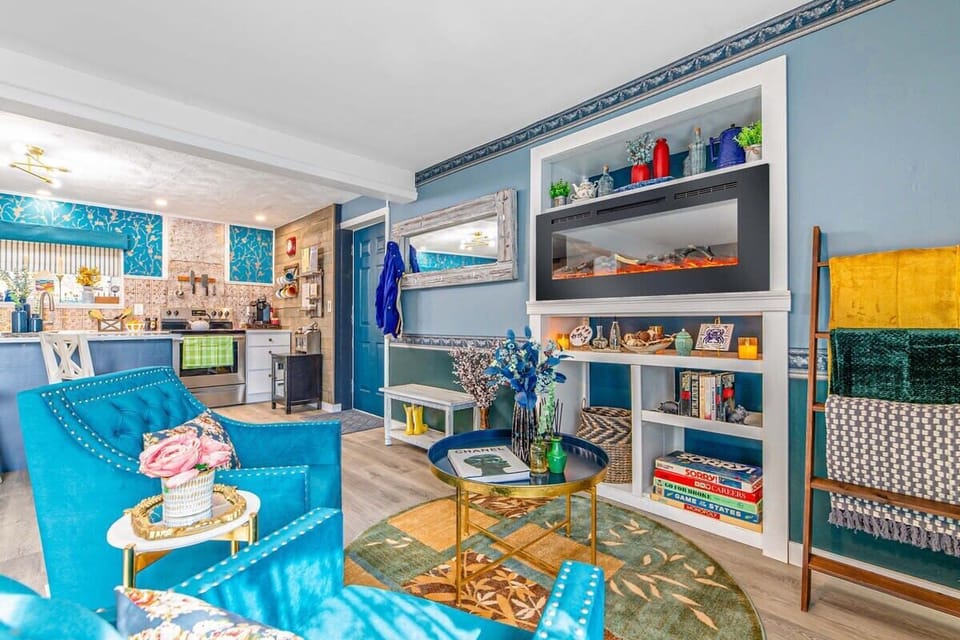 [Lounge, Downstairs] Remember to explore the shelf under the fireplace, where delightful board games and books await for added fun and entertainment.