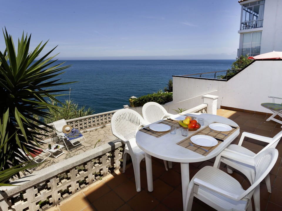 Sky, Water, Table, Building, Furniture, Property, Chair, Seaside Resort, Azure, Outdoor Furniture
