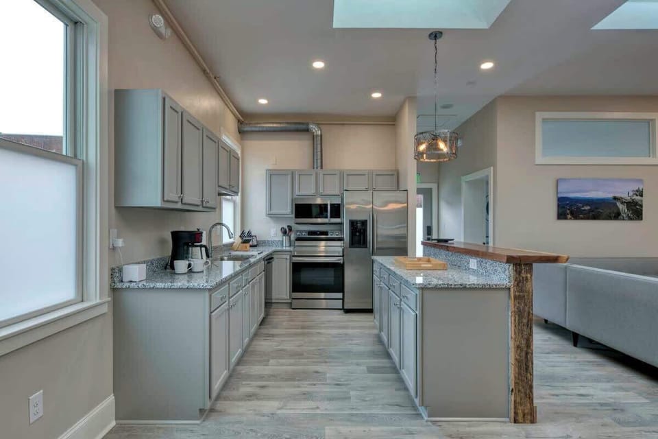 Bright kitchen with island and stainless steel appliances