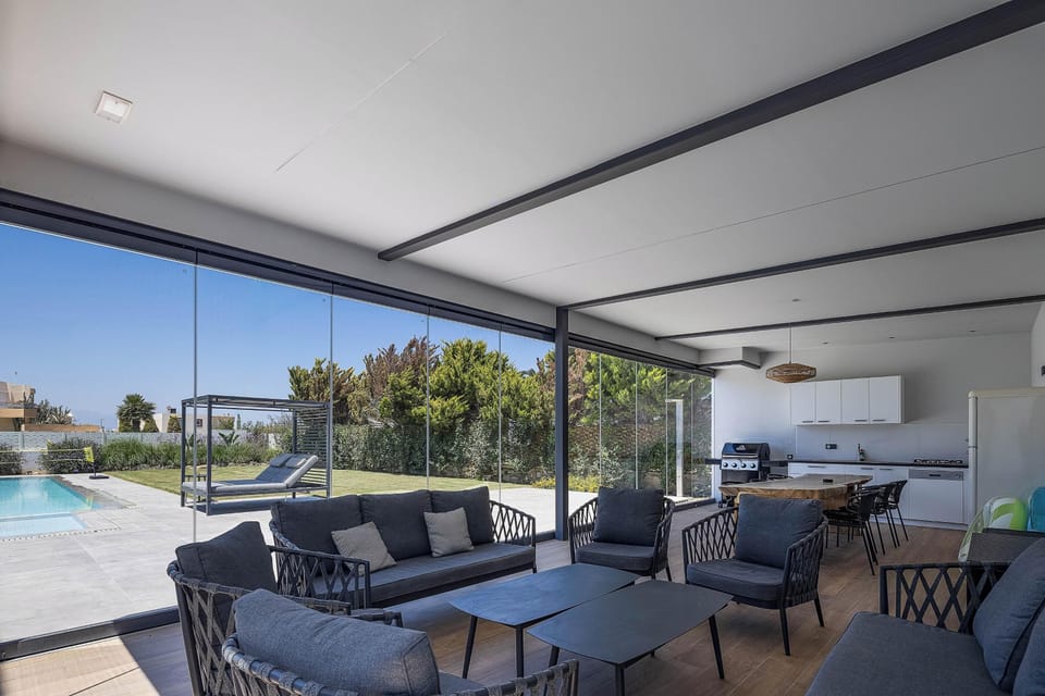 A fully equipped BBQ area with a dining space, which can be enclosed with glass doors or left fully open to enjoy the fresh air.