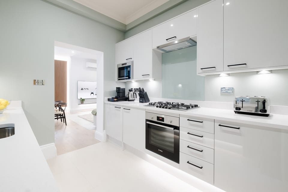 Full Kitchen | Impeccably Stocked Kitchen, Featuring Essential Appliances and Luxuries including a Filtered Water Dispenser and Nespresso Machine with Vertuo Pods Provided. Martini, Champagne, and Wine Glasses Included.