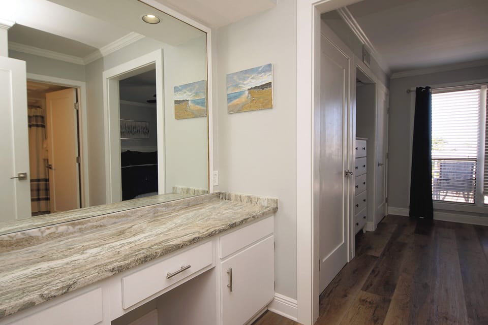 Your luxurious master suite features a stunning granite vanity with custom cabinetry, perfect for your morning routine in elegant style.