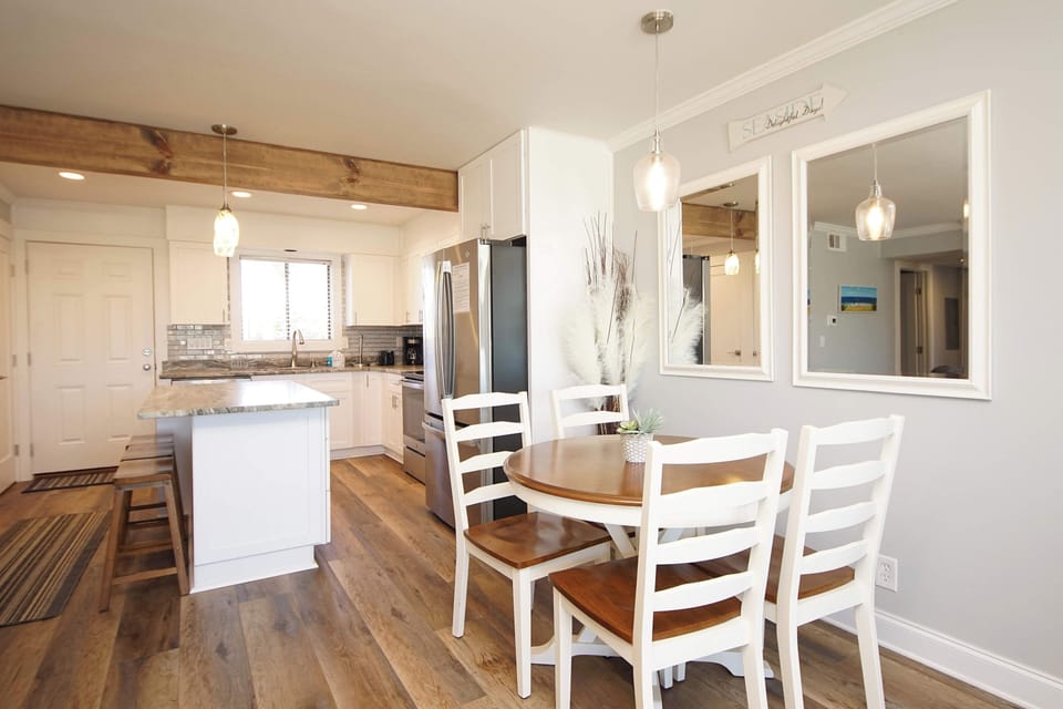 Your open-concept dining and kitchen space welcomes you with warm wood accents and modern coastal charm—perfect for sharing meals together.