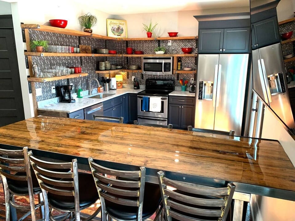 Wow! Exquisite high end Open Kitchen with bar seating for 9 and 75" 4KTV. The shelves were taken from hundred year old whiskey distilleries. Then step right out onto second floor balcony and BBQ 