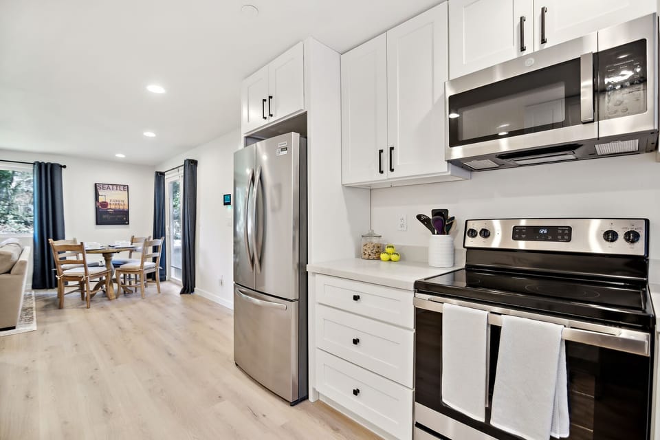 Open concept kitchen with new stainless steel appliances.
