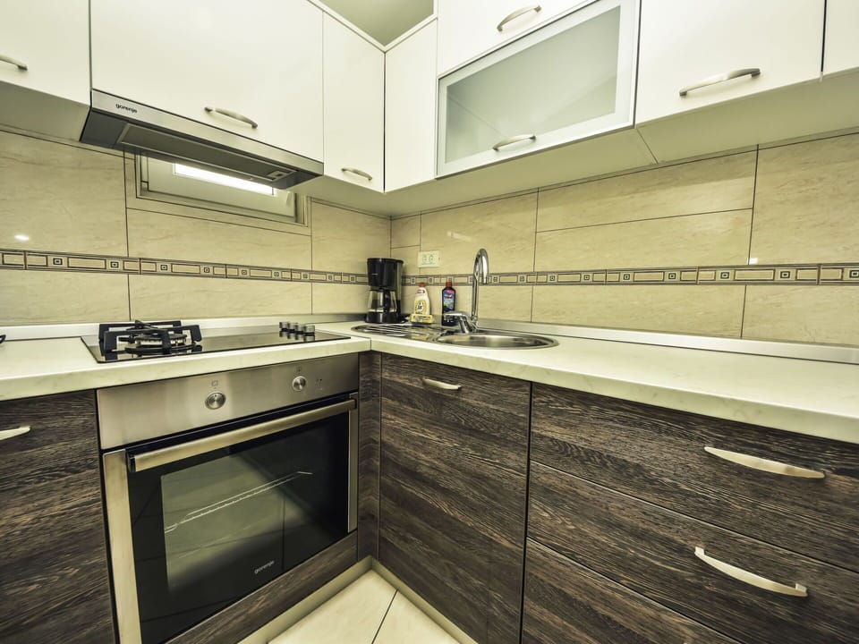 Countertop, Cabinetry, Furniture, Kitchen Stove, Building, Kitchen, Tap, Wood, Kitchen Appliance, Interior Design