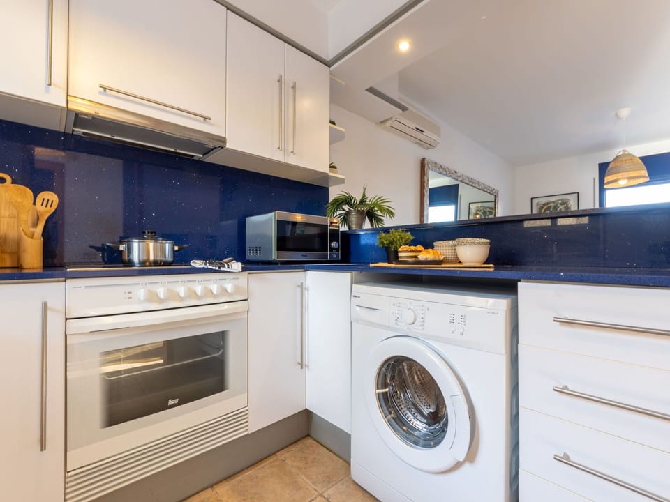 Cabinetry, Property, Countertop, Washing Machine, Home Appliance, Laundry Room, Kitchen Appliance, Kitchen Stove, Clothes Dryer, Kitchen