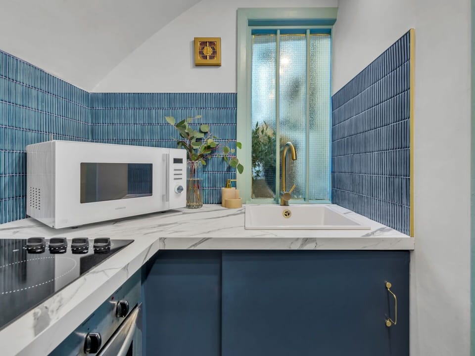 Blue, Kitchen, Countertop, Interior Design, Flooring, Cabinetry, Lighting, Ceiling, Plumbing Fixture, Tile