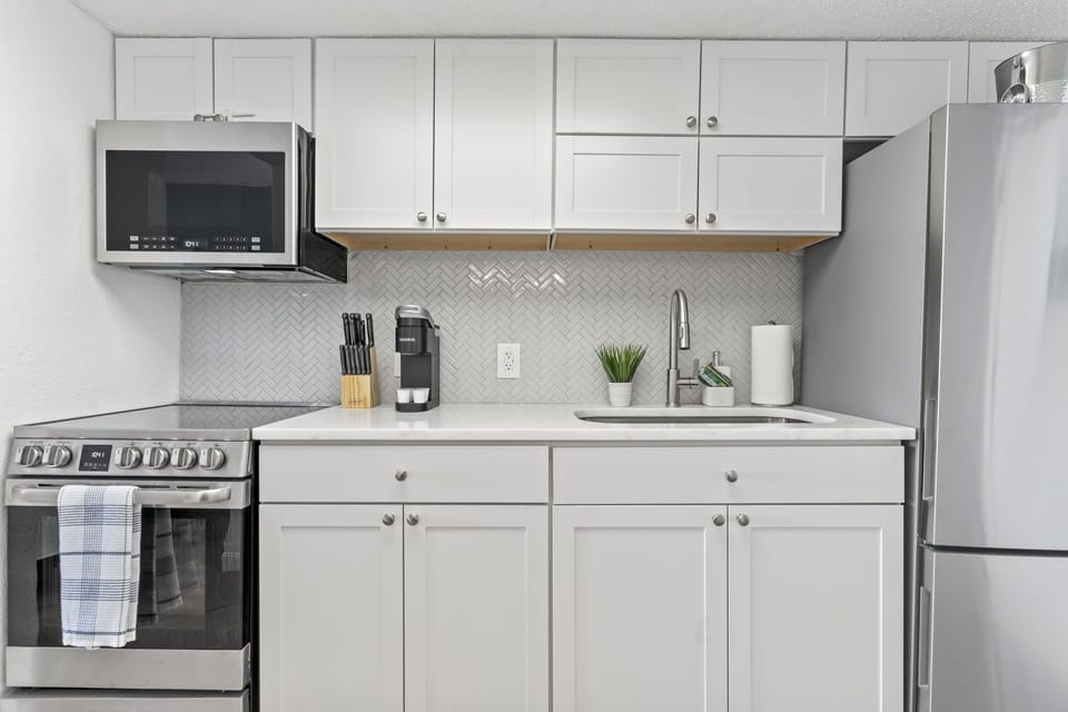 Full-size appliances in a sleek, renovated kitchen.