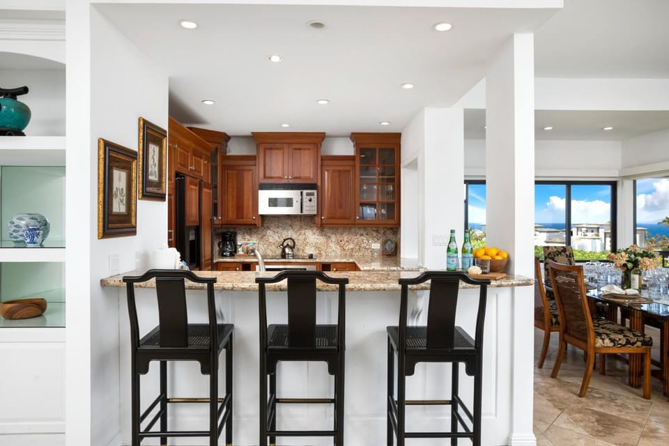 Inviting kitchen bar opens to ocean-view dining experience nearby.