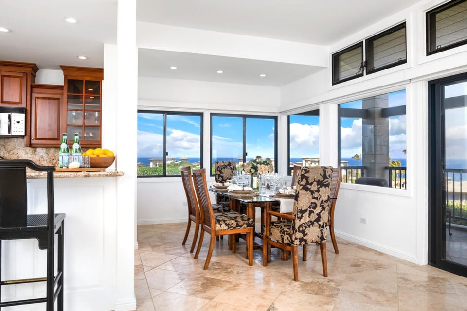 Spacious dining retreat with ocean views and elegant tropical decor.