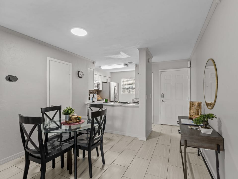 Dining room for 4 people with kitchen, bathroom and front entrance view