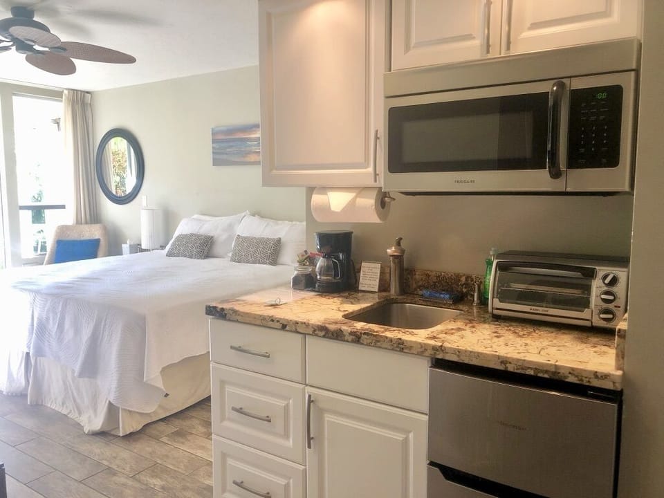 Kitchenette with under counter fridge, dedicated freezer, microwave and more. 