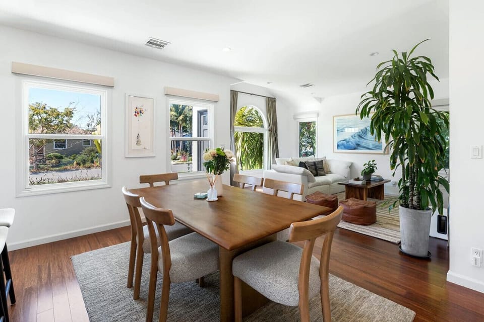 This modern dining area boasts a stylish table and convenient bar seating, creating a seamless flow between dining and conversation.