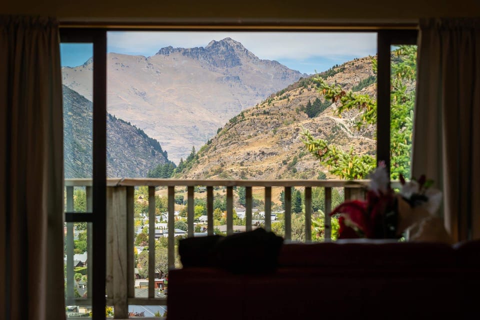 Living Room: Breathtaking mountain views await you through expansive windows! Relax and unwind!