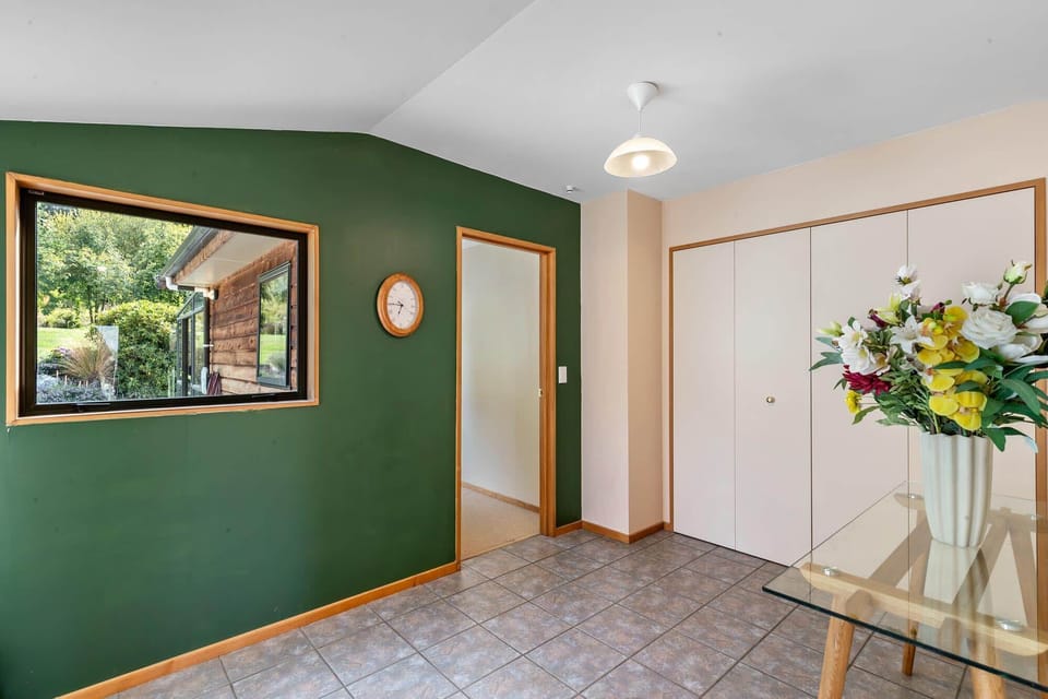Entryway: Bright and inviting space with vibrant green walls and stunning natural views!