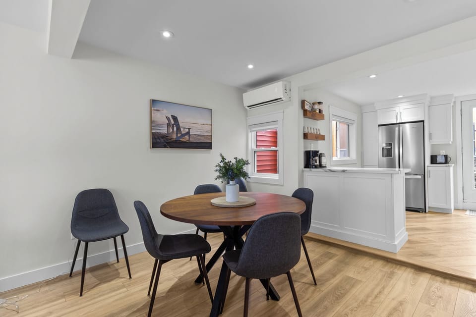 Dine and unwind in this welcoming space! A cozy dining area paired with a sleek kitchen equipped with all the essentials for a memorable stay.