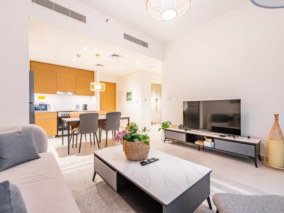 Deluxe Apartment | Living area | 55-inch LED TV with cable channels