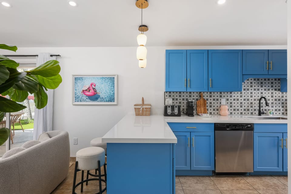 Chic Palm Springs kitchen made for connection. Bright blue cabinets, modern touches, and space to create and unwind.