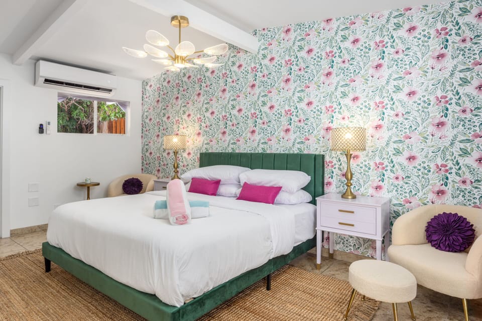 A romantic Palm Springs retreat with floral walls, soft light, and timeless vintage style. Sleep, relax, and dream away.
