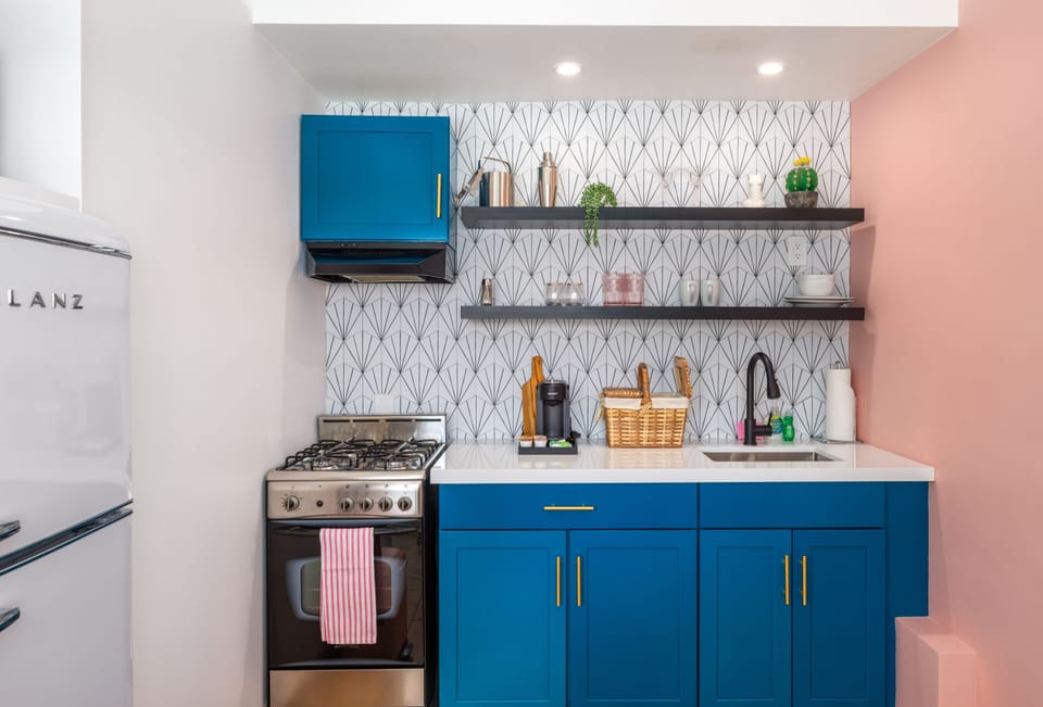 Whip up breakfast in this chic Palm Springs kitchenette with bold blue cabinets and retro charm. Fully stocked for coffee, cocktails, or a cozy weekend getaway.