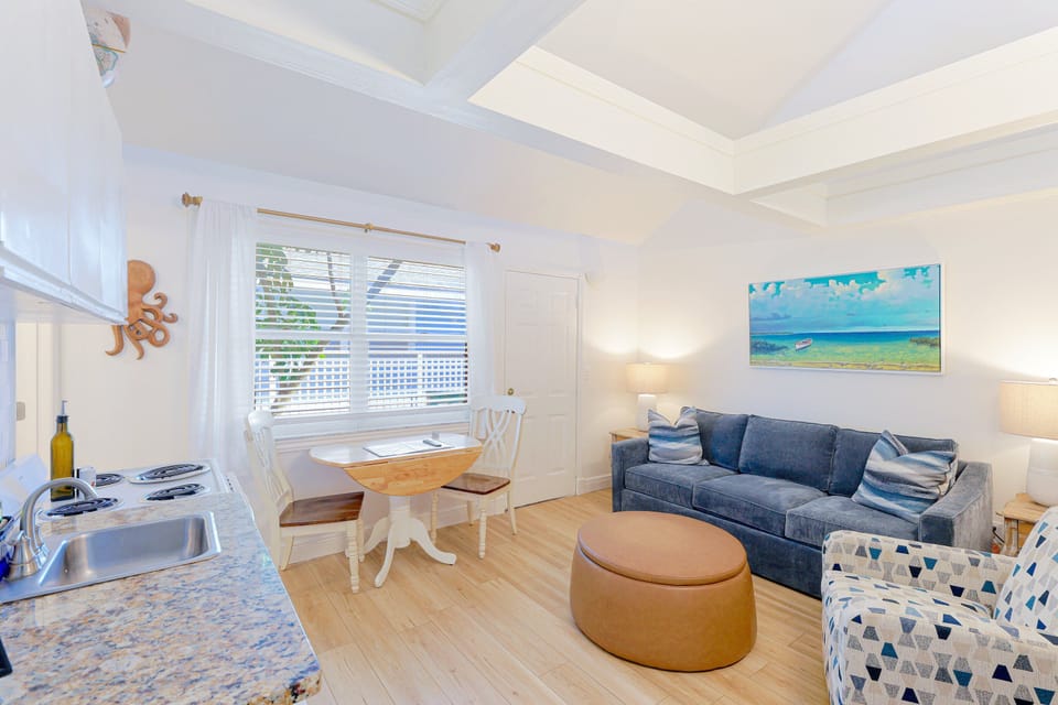Bright open-plan living space with dining nook, sofa seating, and natural light at the Siesta Key 3BR.