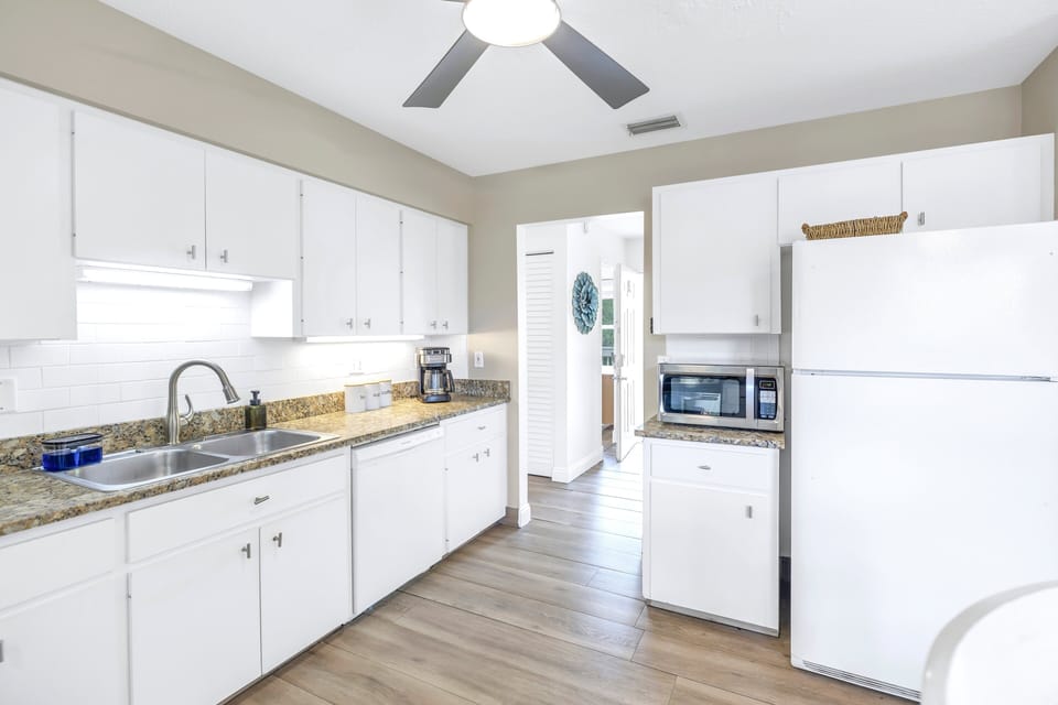 Spacious kitchen with updated appliances and plenty of counter space at The Coral Cabanas, Siesta Key.