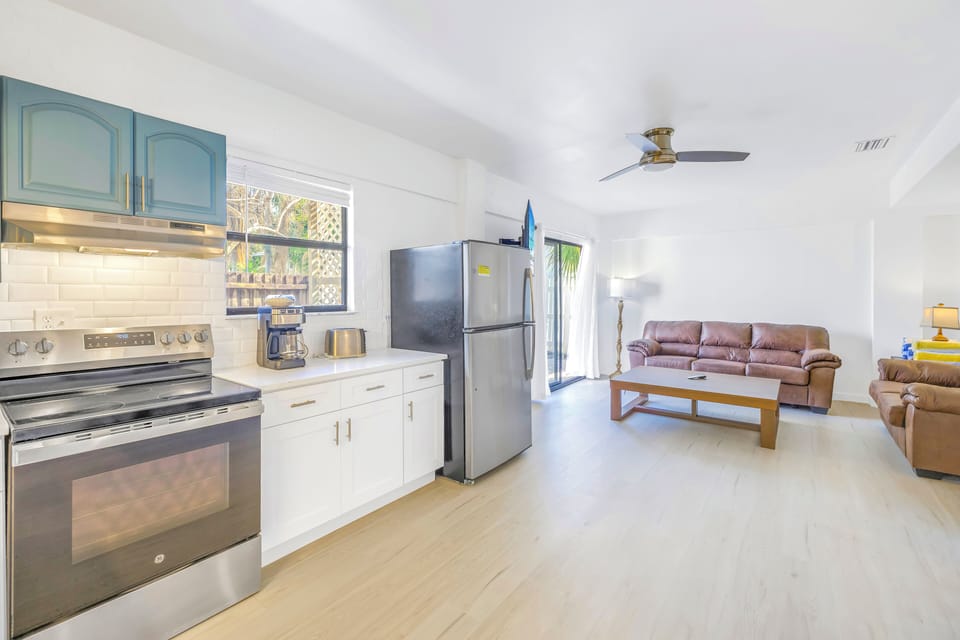 Newly updated living and kitchen area with open layout and modern finishes at The Coral Cabanas, Siesta Key 2BR.